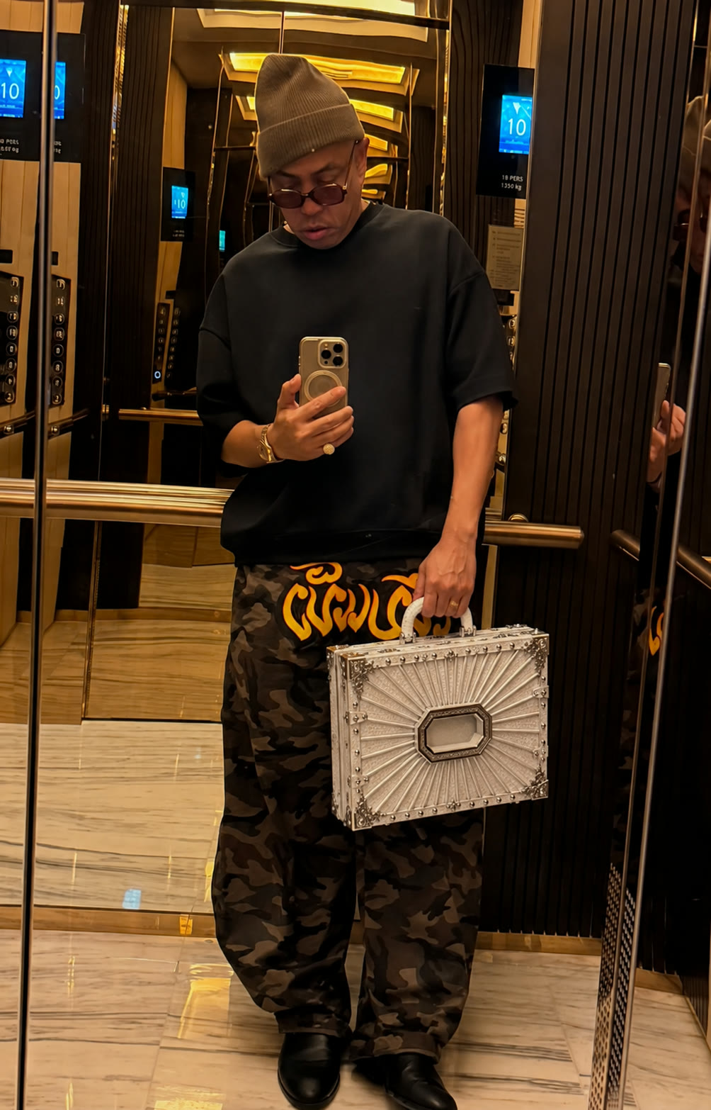 Joe Flizzow mirror selfie in a lift, white and silver case