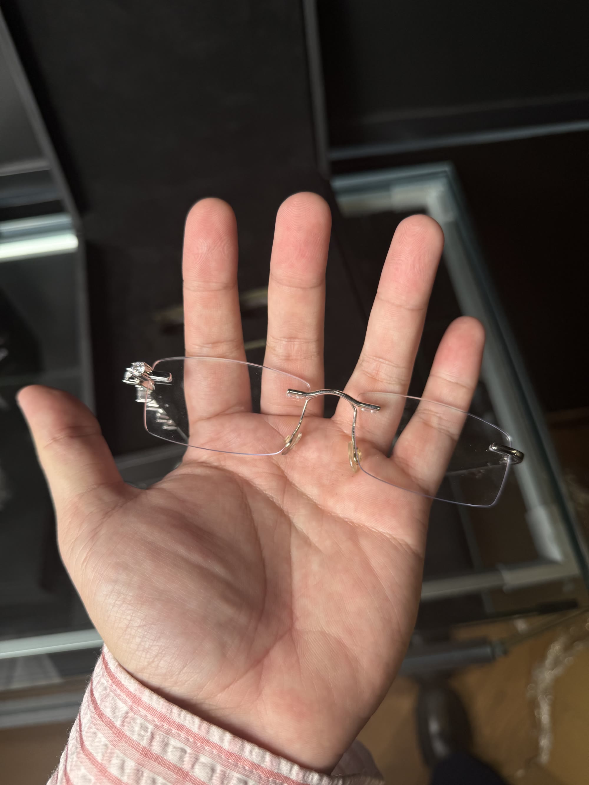 The full rimless frame held in a palm